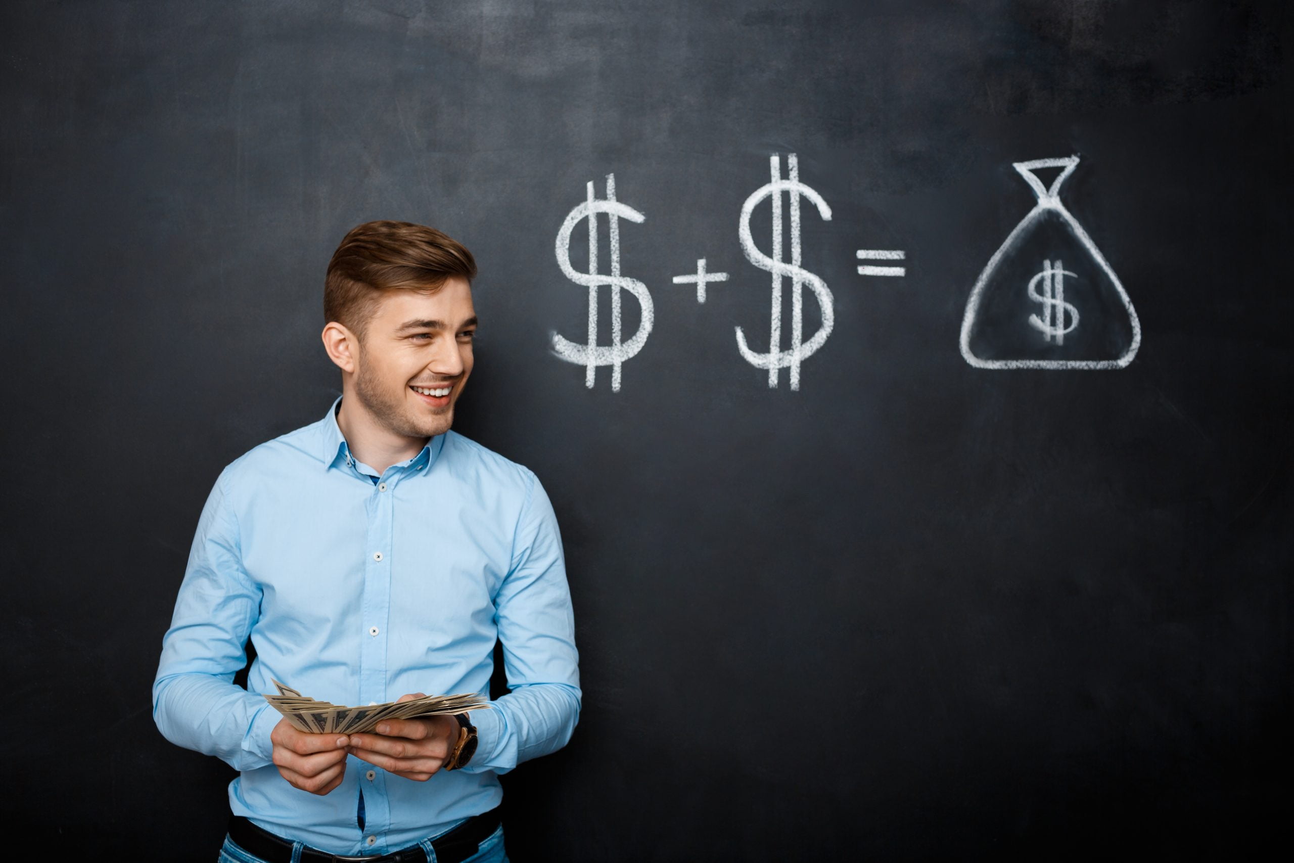 handsome man standing over blackboard with drawn dollar concept